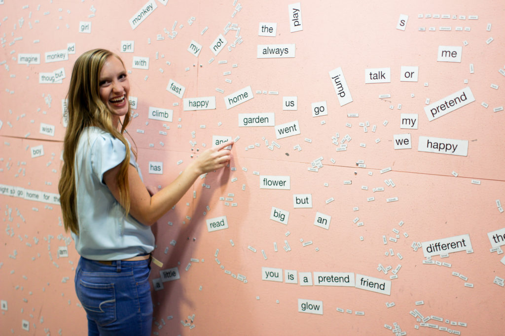 Word magnets on a pink wall at Love Letters Museum