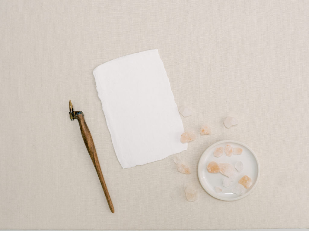 Writing conversational copy: An ink pen with a textured paper and pink Himalayan salt